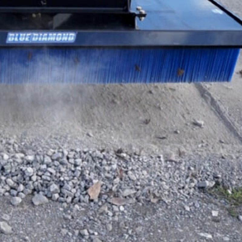 blue diamond push broom attachment in action