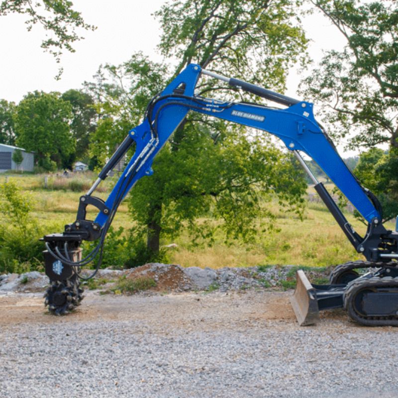 skid steer with blue diamond rock and concrete grinder attachment