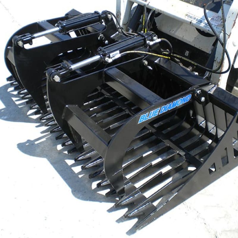 Blue Diamonds Standard Duty Rock Bucket Grapple closed attached to skid steer
