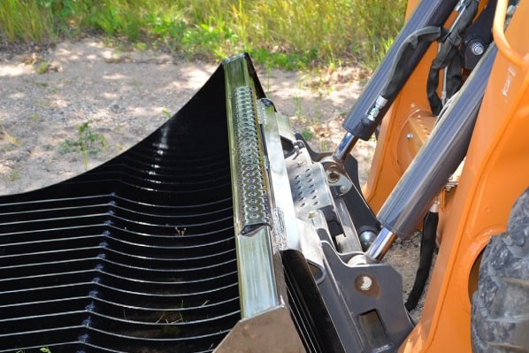 skid steer with the rock bucket attachment from top dog