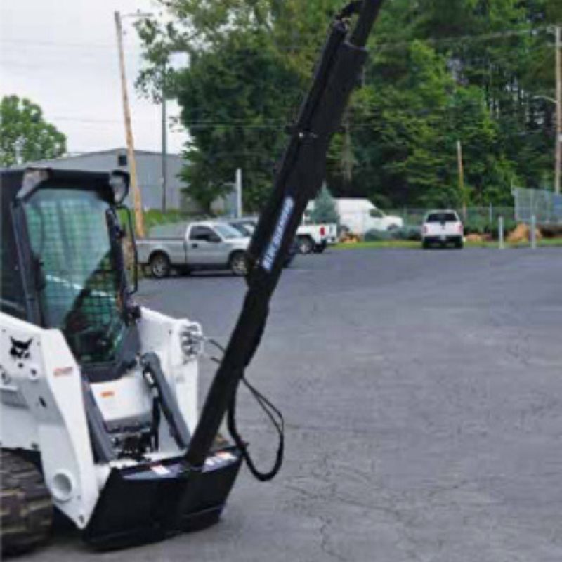 skid steer in action with blue diamond roof truss jib attachment