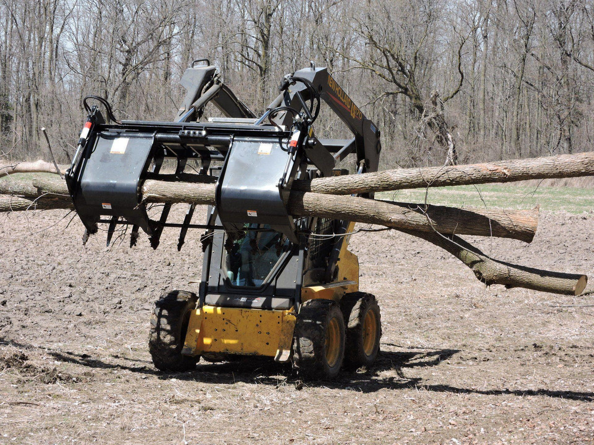 skid steer in action grappling trees in the field with the root grapple attachment from berlon industries