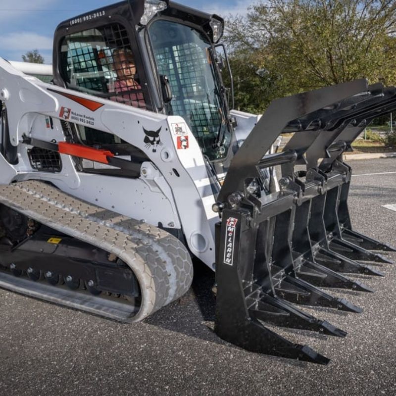 side view of the root rake grapple attachment  on bobcat skid steer from mclaren industries