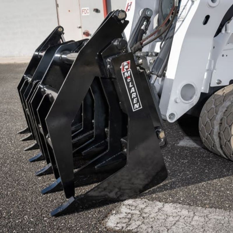 Vertical Root Rake Grapple attachment on the ground from McLaren Industries