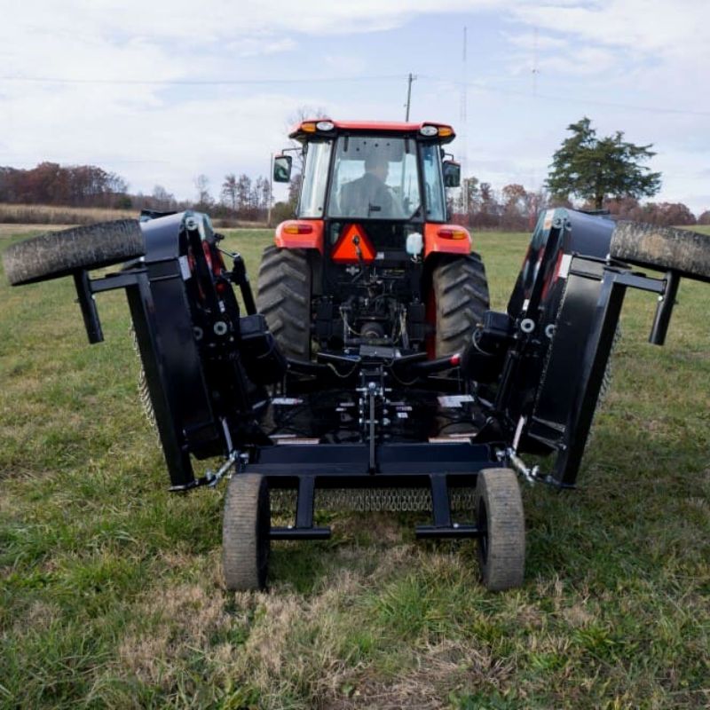 skid steer with the blue diamond rotary cutter flex wing attachment in action