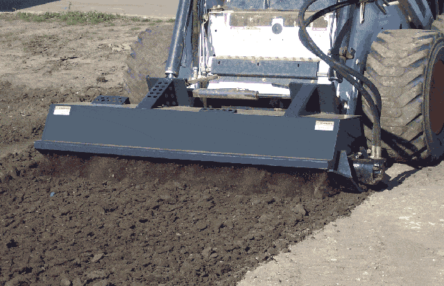 Rotary tiller being used in reverse on a skid steer from haugen attachmenrs