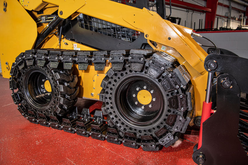 rubber over the tire tracks on a skid steer by mclaren industries