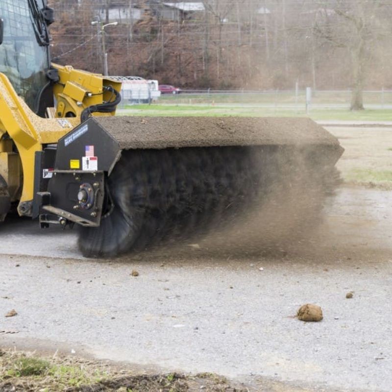 caterpillar skid steer with sweeper attachment from blue diamond
