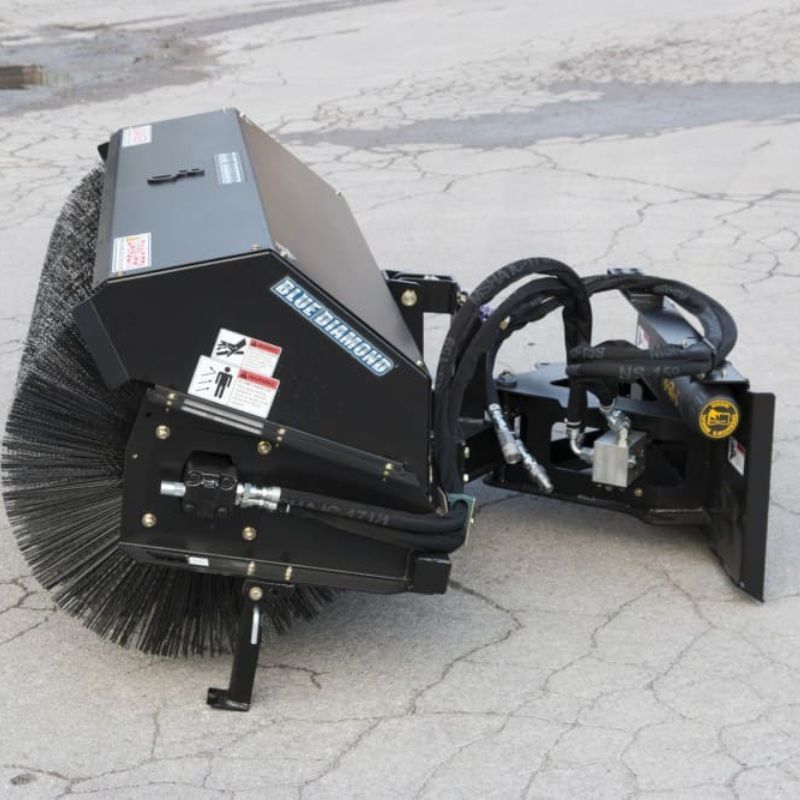 blue diamond sweeper attachment for skid steer on the ground