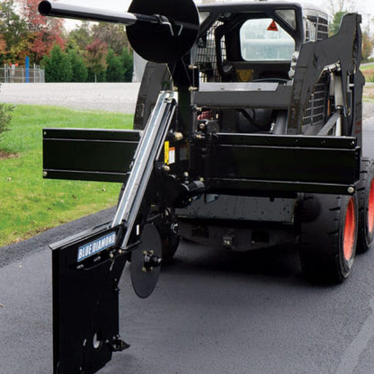 skid steer in use with the blue diamond silt fence installer attachment