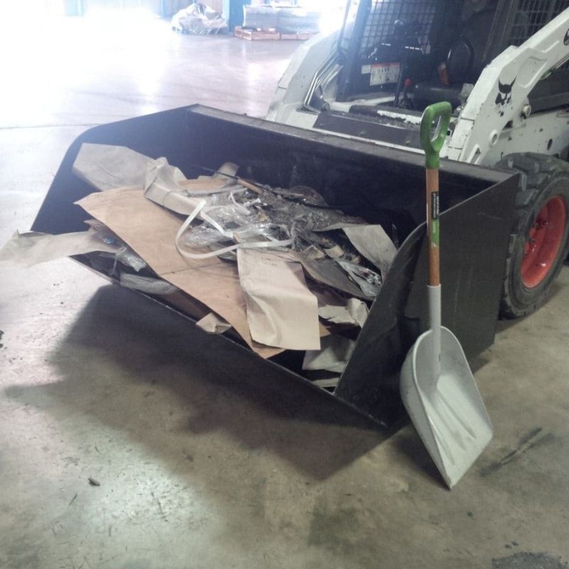 blue diamond dumpster bucket for a bobcat picking trash.