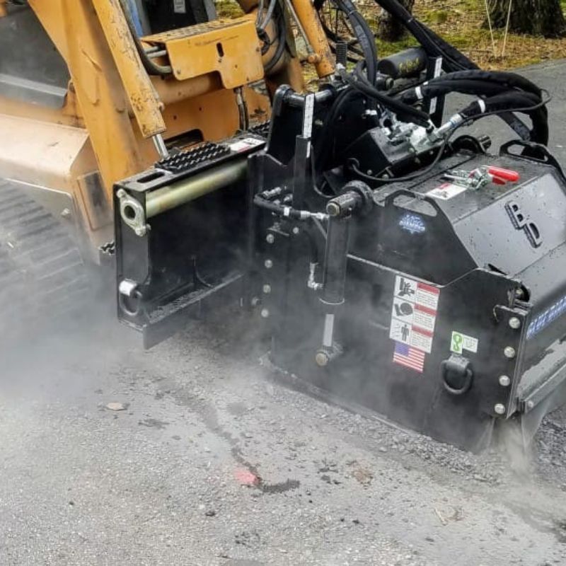 skid steer with the blue diamond cold planer in action 