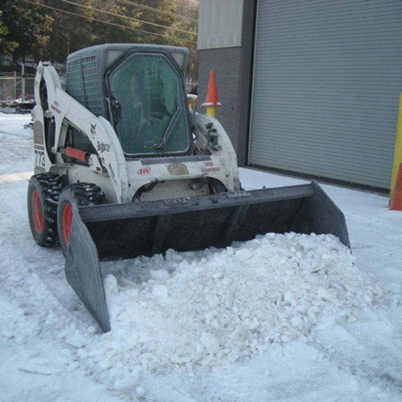 skid steer with the blue diamond snow and mulch bucket attachment in action