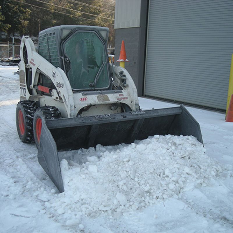 skid steer in action with the blue diamond heavy duty snow and mulch bucket attachment