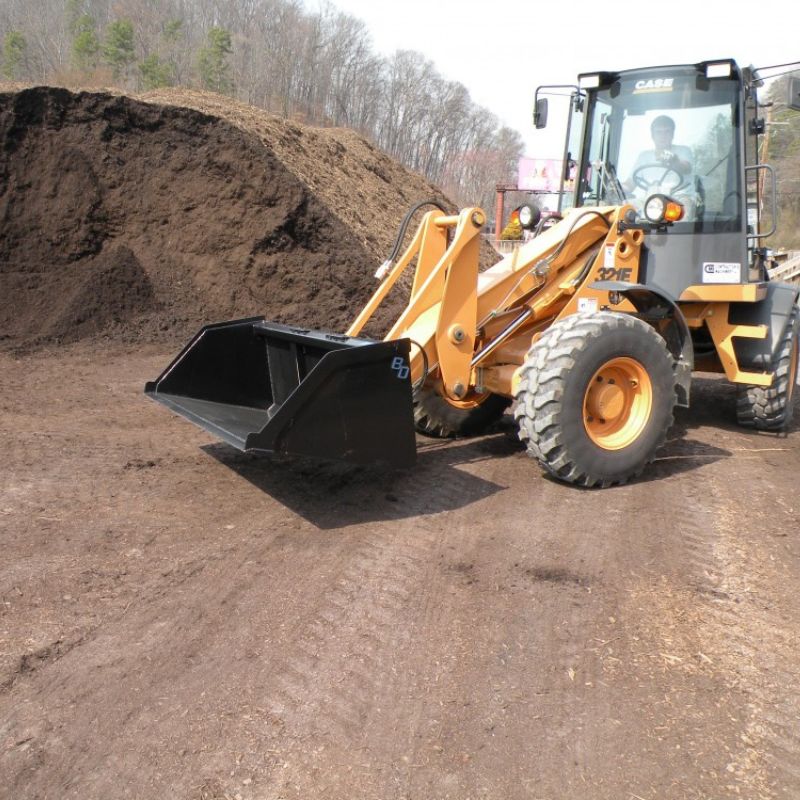 case skid steer in the field with the blue diamond hd snow and mulch bucket