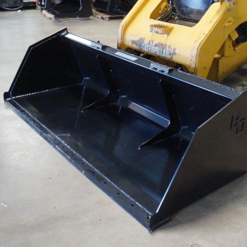 blue diamond heavy duty snow and mulch bucket attached to a cat skid steer