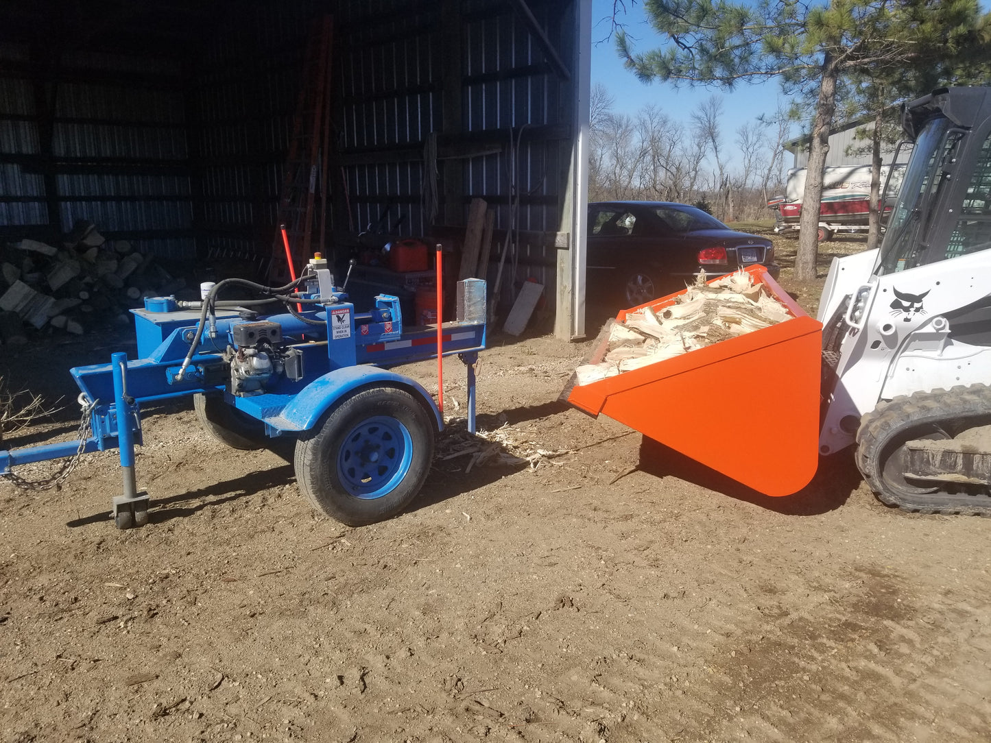 orange-snow-bucket-attachment-in-the-field-by-tm-manufacturing