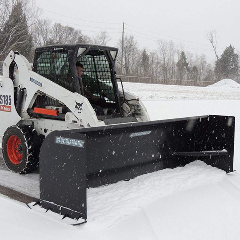 skid steer pushing snow with the blue diamond standard duty snow pusher
