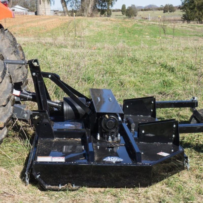 tractor with blue diamond spindle cutter attachment