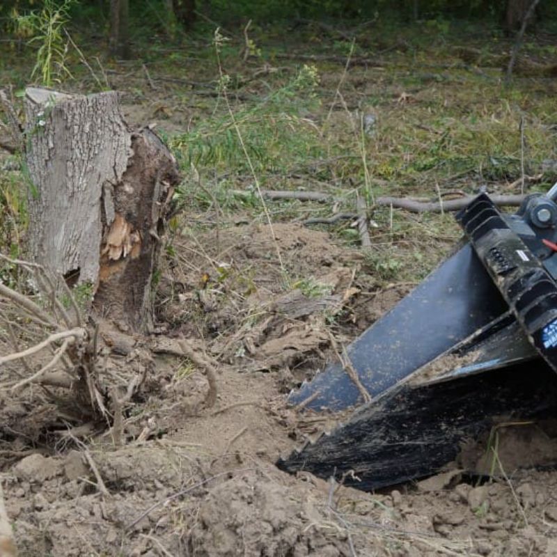 blue diamond stump bucket attachment in action