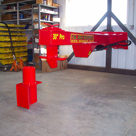 TM Pro 2 Series Log Splitter in workshop with replaceable single wedge next to it