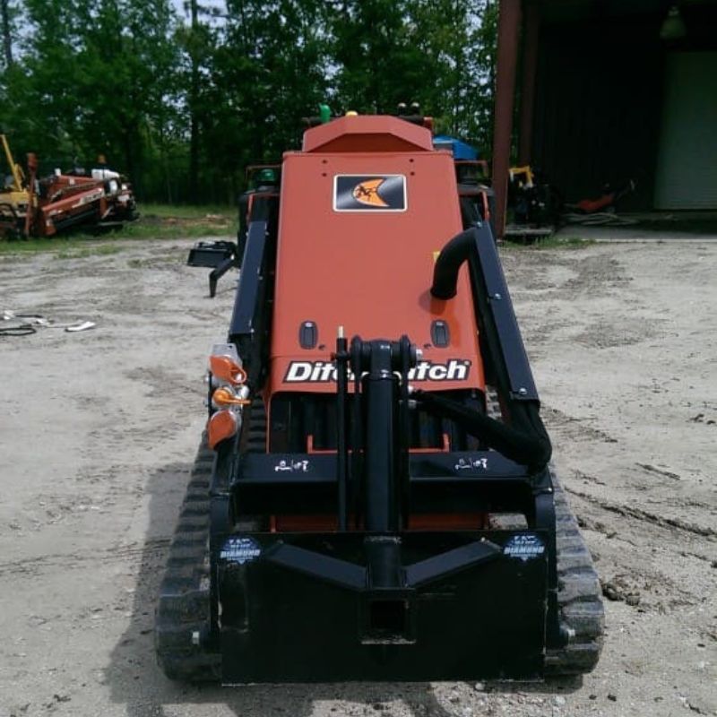 ditch witch mini skid steer with blue diamond trailer spotter