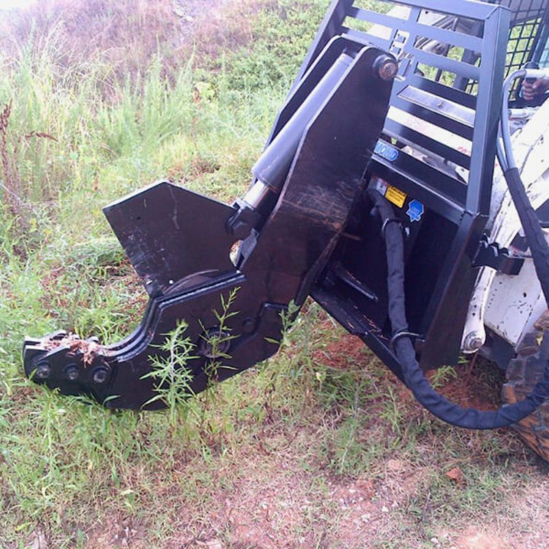 bobcat with the blue diamond rotating tree sheer attachment